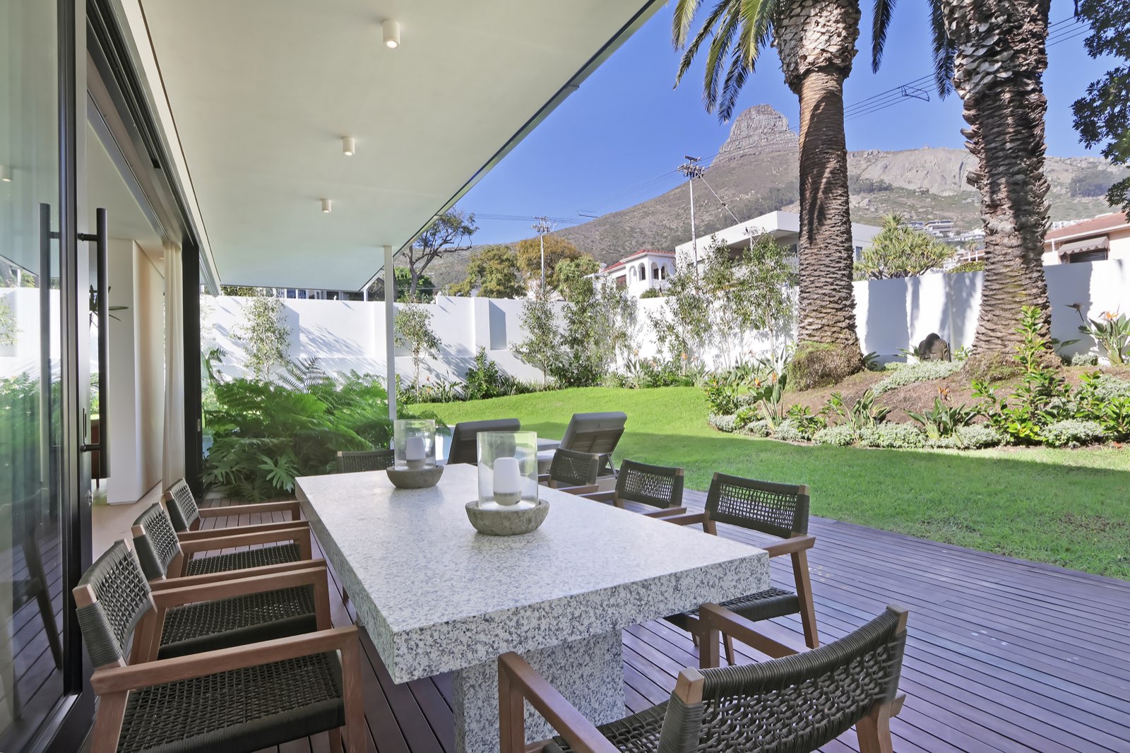 Granite dining table under palm trees