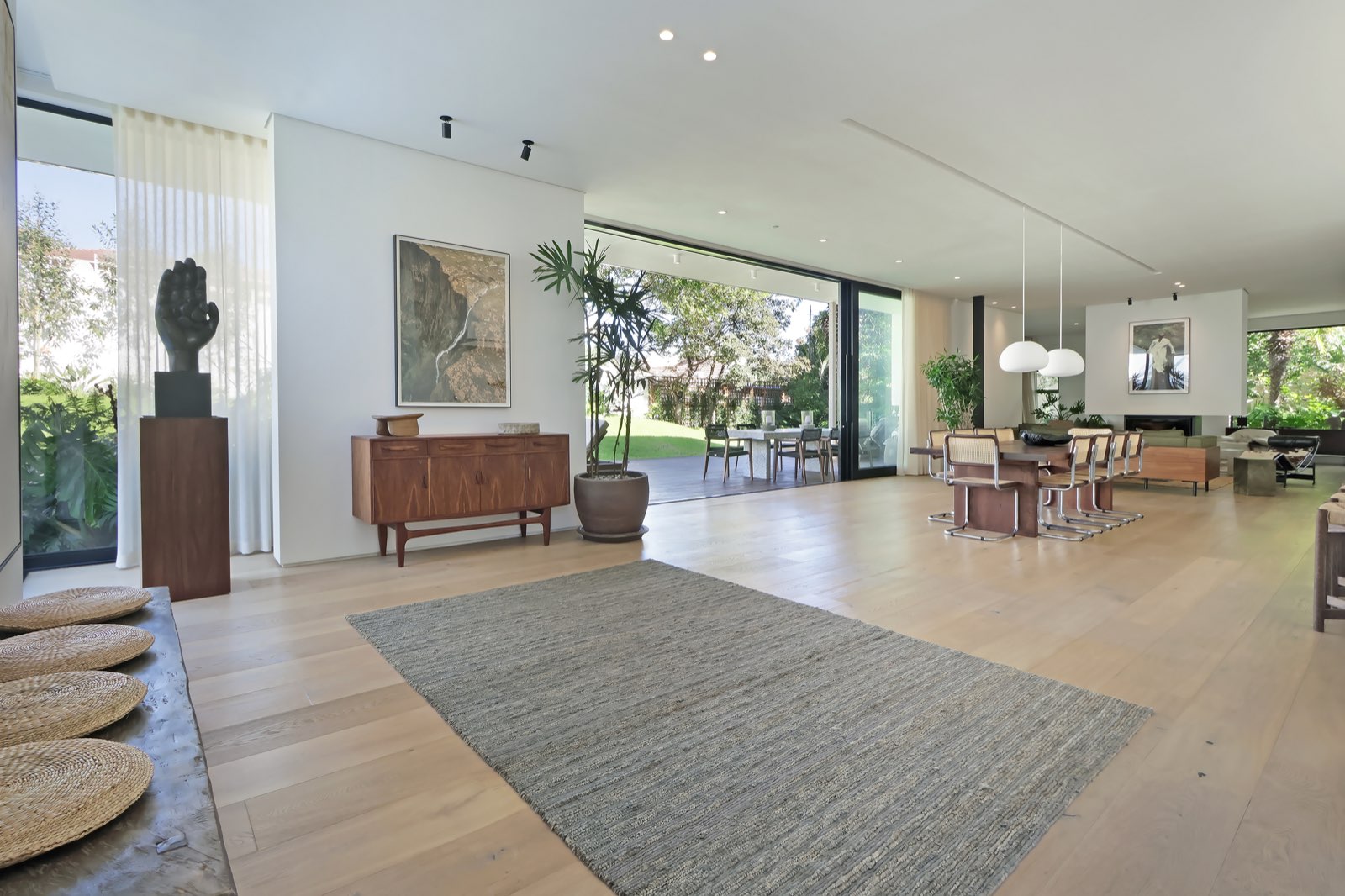 Open-plan living with art sculpture and walnut furniture