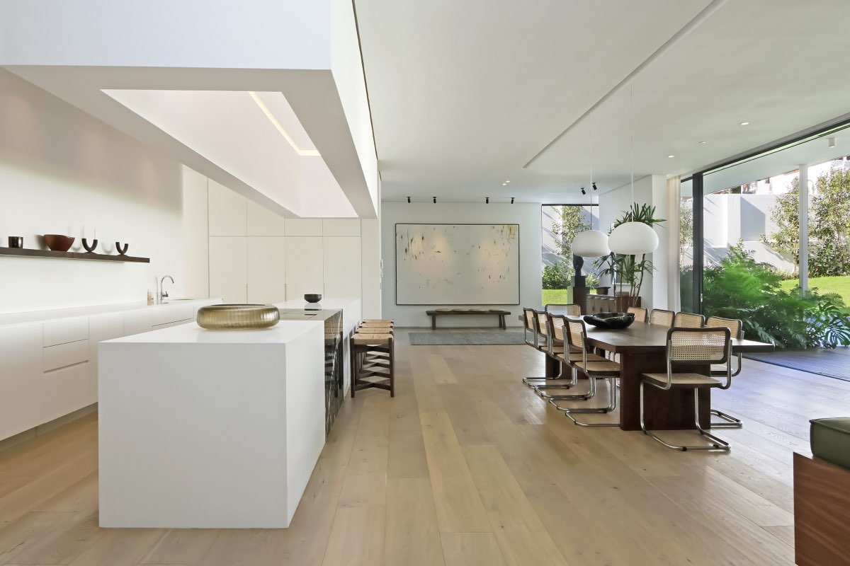 White kitchen island with skylight and garden view