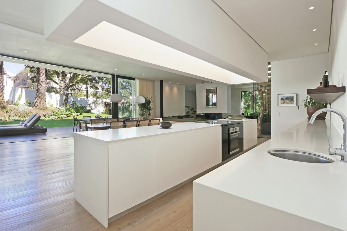 Kitchen opening to garden and pool