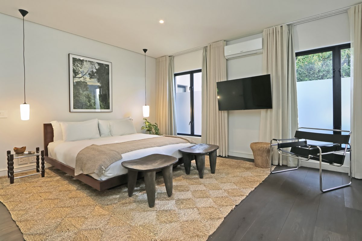 Bedroom with pendant lights and art