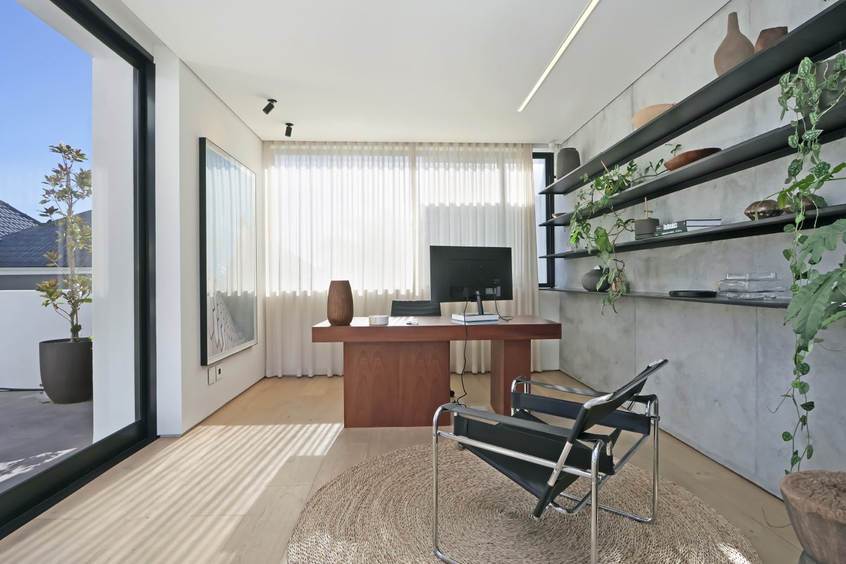 Home office with concrete walls and plants