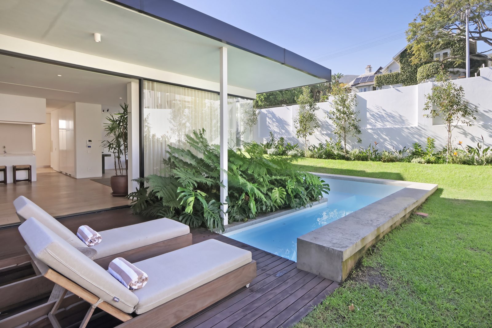 Pool deck with sun loungers and rolled towels